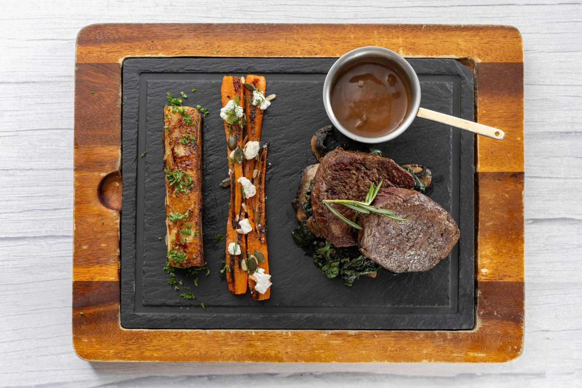 منتجع شاطئ لو ميريديان بوكيت Karon المظهر الخارجي الصورة A steak and vegetables prepared on a slate plate